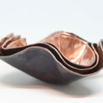 Set of small nested copper bowls
