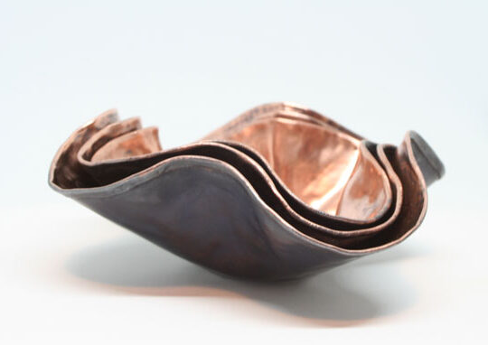 Set of small nested copper bowls