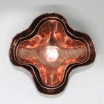 Set of small nested copper bowls